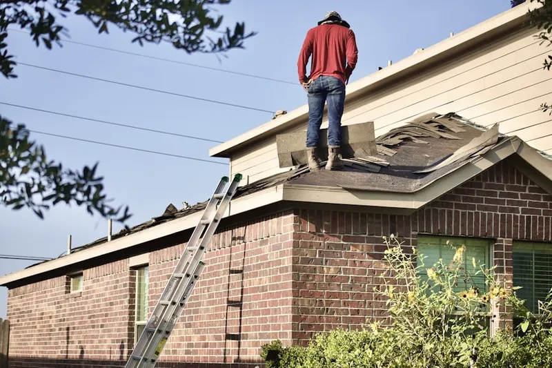 Professional roofer working on a residential roof in Revere Run